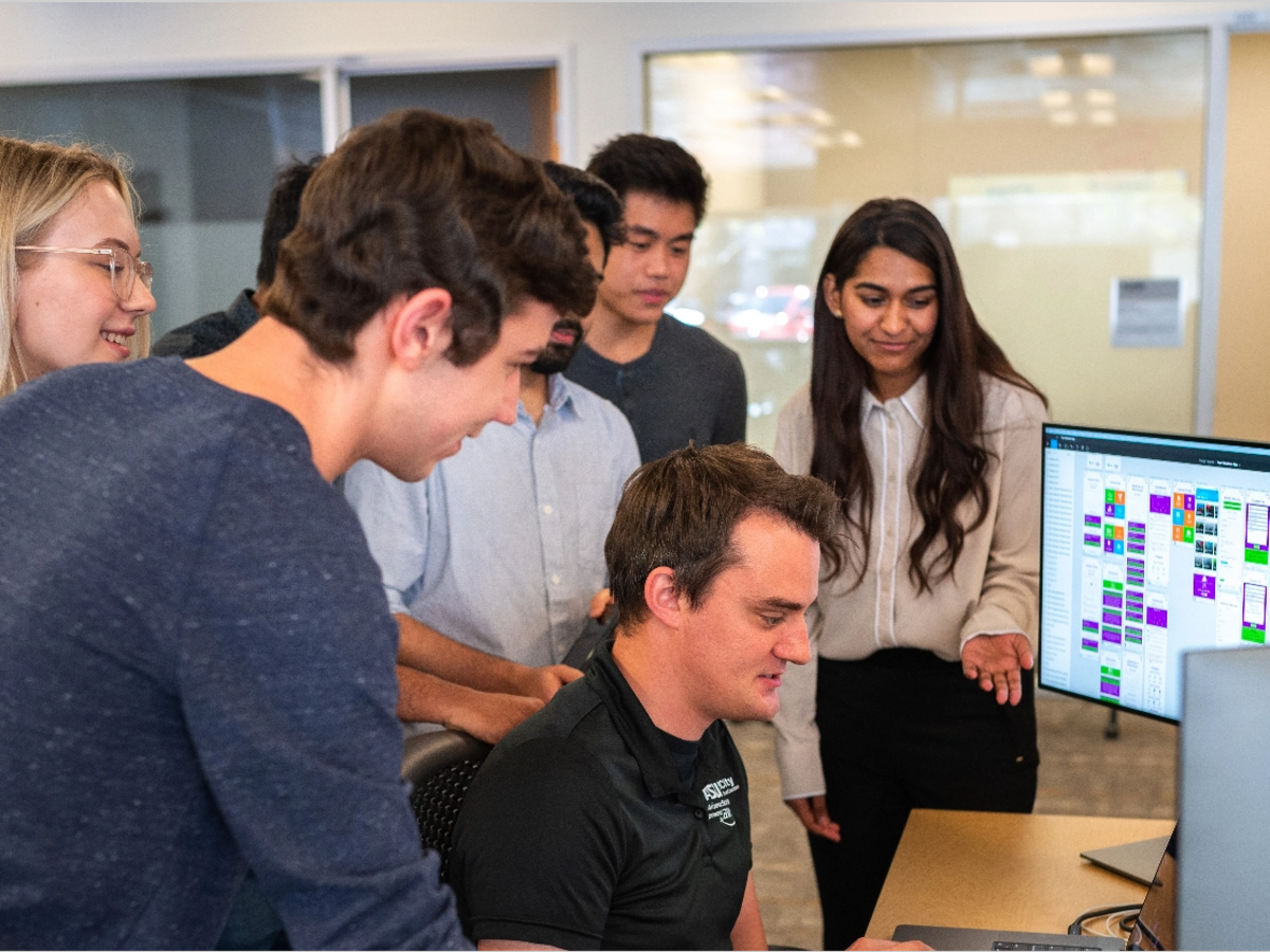 People working around a computer