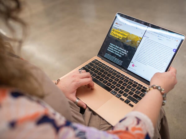 A view over the right shoulder of a student of a laptop screen 