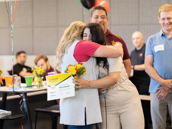 Walizada embraces Tina Miller of ASU Enterprise Technology.