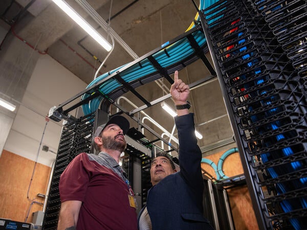 Two men in a network room 