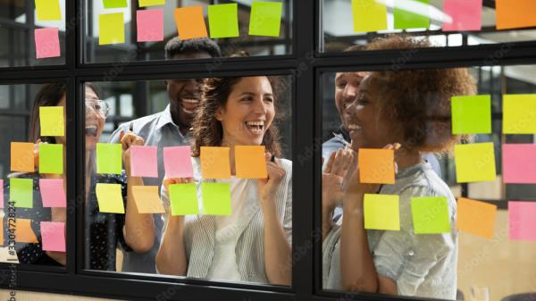 people working together with post its