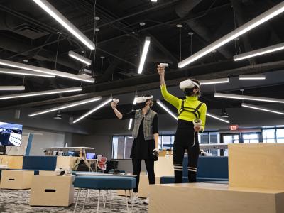 Users stand and use virtual reality headsets