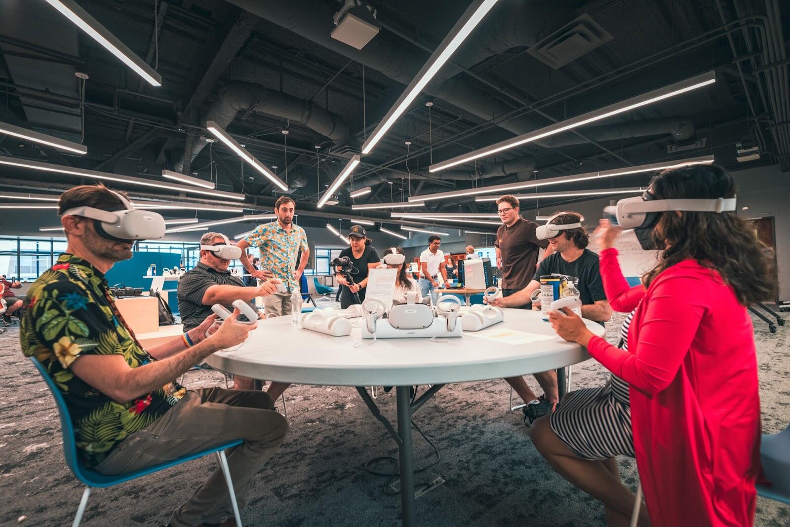 Participants use virtual reality headsets around a table