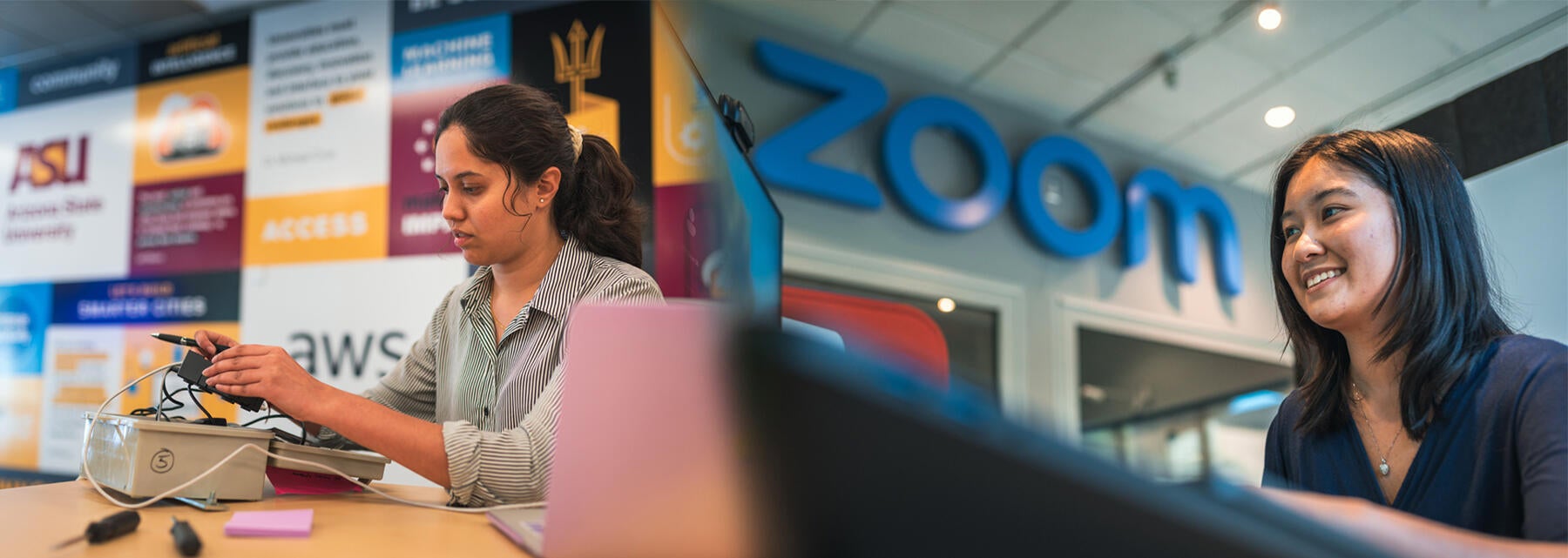 Two women at sitting at computers. 