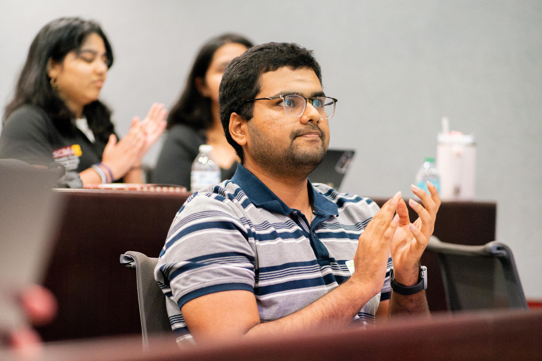 Students clap during a presentation at the OpenAI and Student Success Spark Challenge