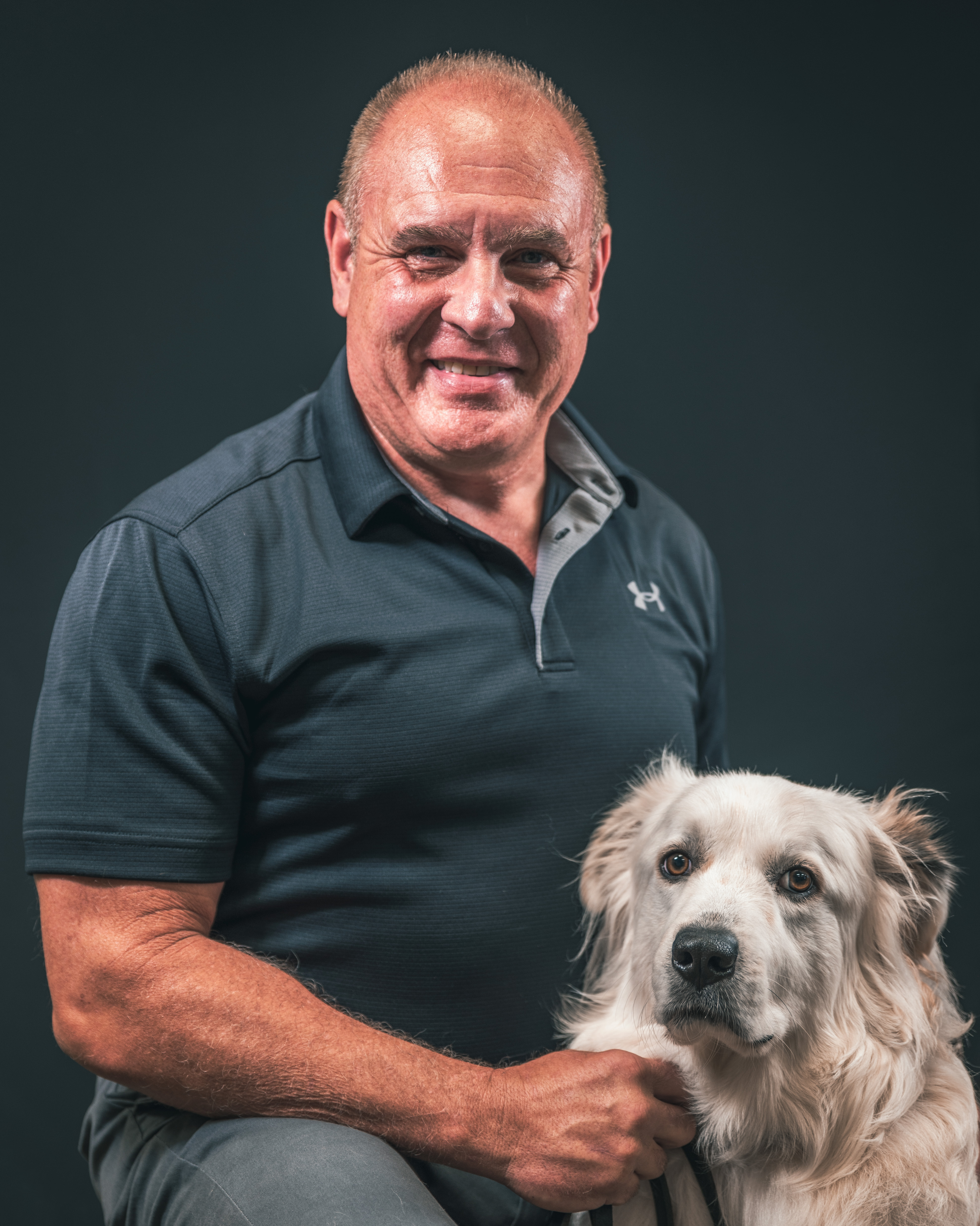 Man sitting with dog on right. 