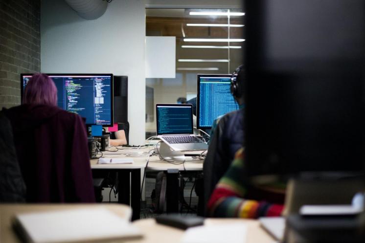 Image of people typing on computers