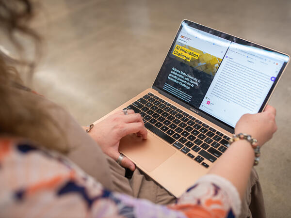 A view over the right shoulder of a student of a laptop screen