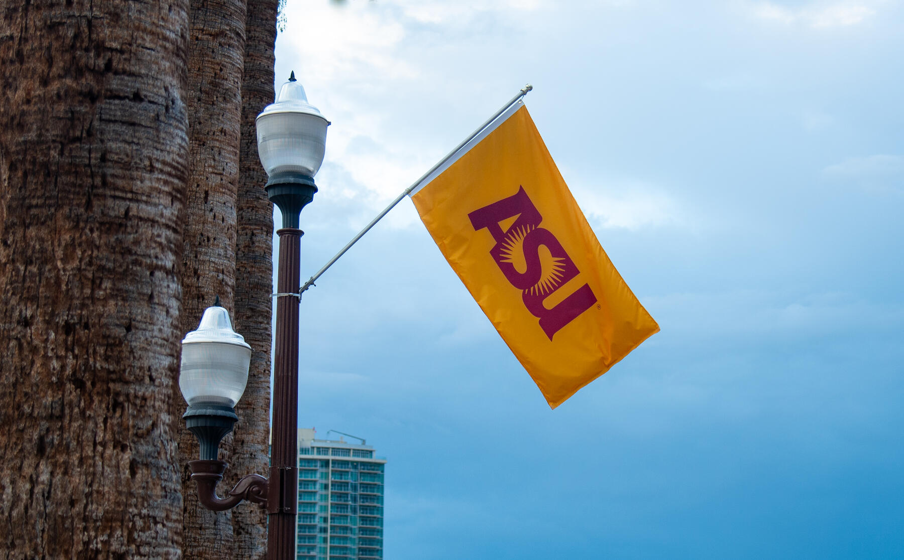 Gold flag with the letters ASU in maroon 